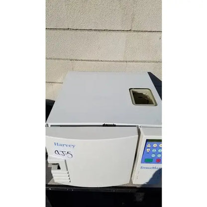 White plastic laboratory centrifuge harvey sterilemax st75935 with digital control panel labeled harvey qj5