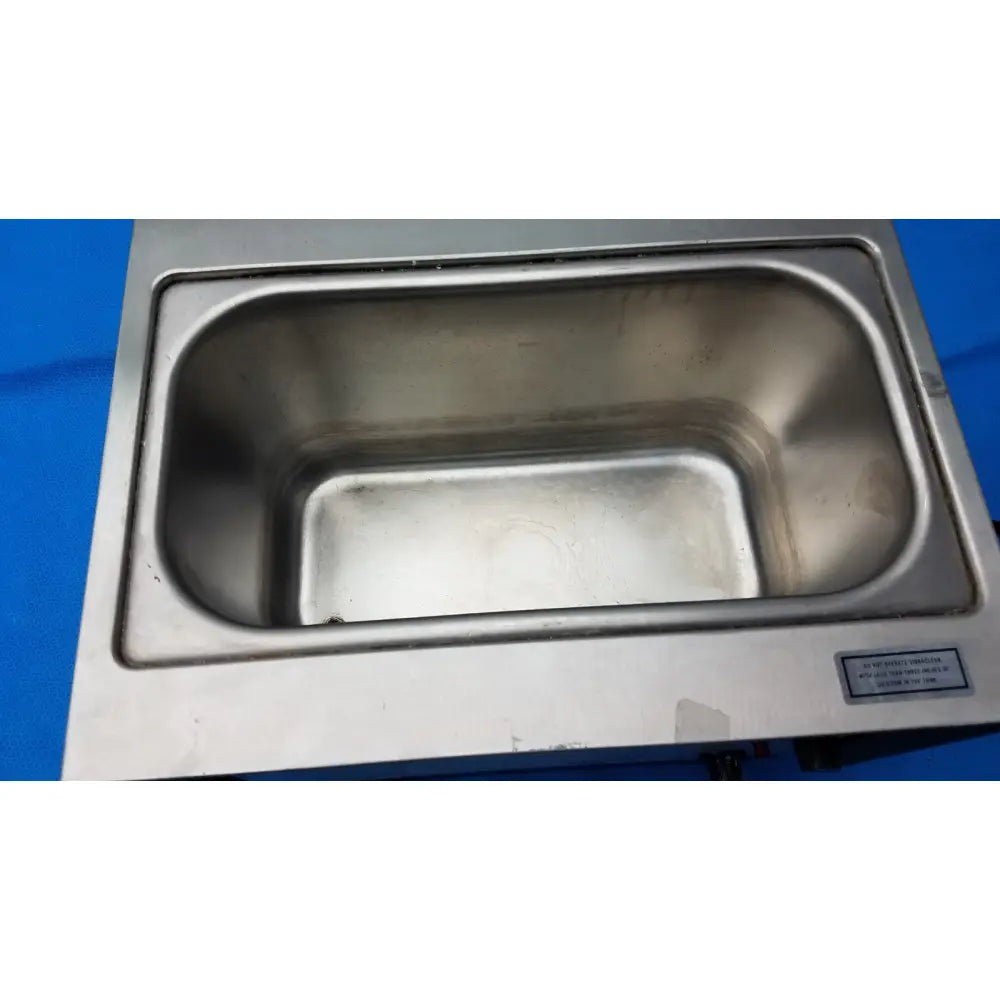 Stainless steel rectangular sink with smooth reflective interior and raised edges in harvey vibraclean model 200