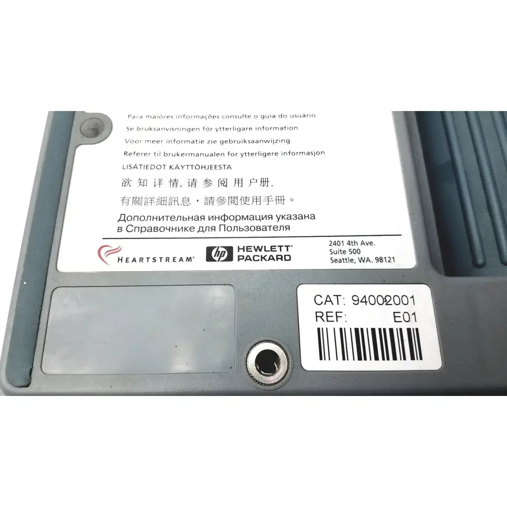 Gray plastic heartstream eo1 semi automatic defibrillator back with barcode label and multilingual user manual reference