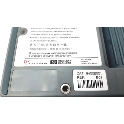 Gray plastic heartstream eo1 semi automatic defibrillator back with barcode label and multilingual user manual reference