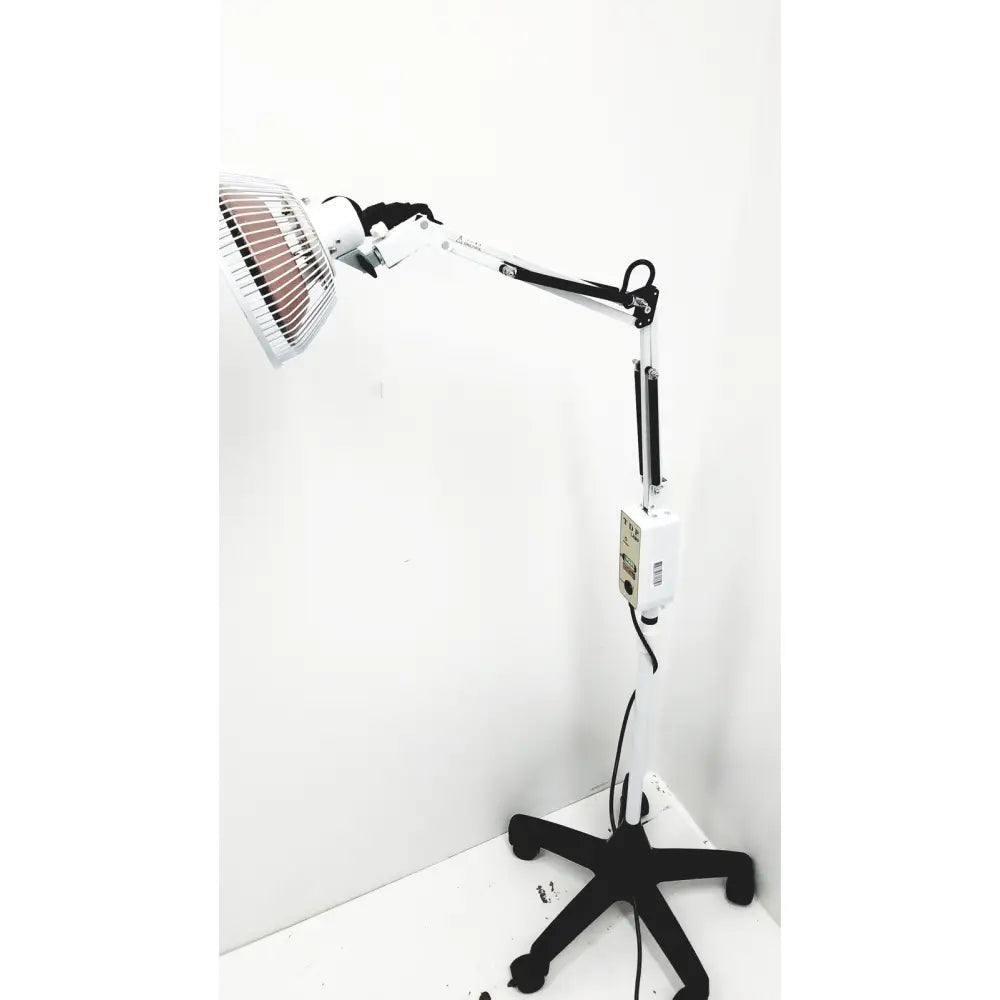 White adjustable heat tdp lamp with black articulated arm and metal grille housing infrared heating element tall lamp