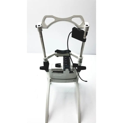 White metal dental chair with black accents and adjustable armrests for Heidelberg Engineering HRTI laser head model LSC210