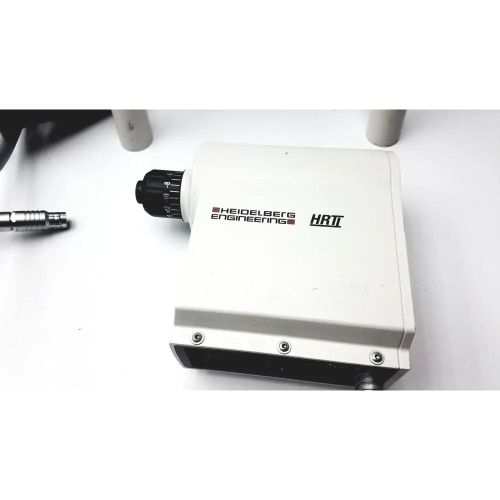 White rectangular microscope stage with black knurled focus knob and heidelberg engineering hrti branding for hrti laser head