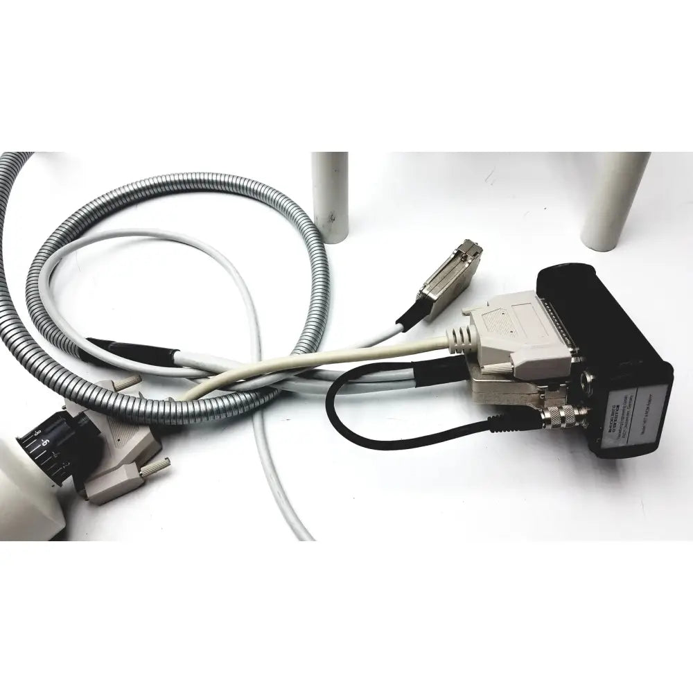 Black and beige industrial data interface module with metallic d-sub connector and cables on the back of heidelberg engineering hrti laser head model lsc210