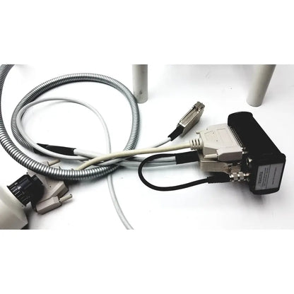 Black and beige industrial data interface module with metallic d-sub connector and cables on the back of heidelberg engineering hrti laser head model lsc210