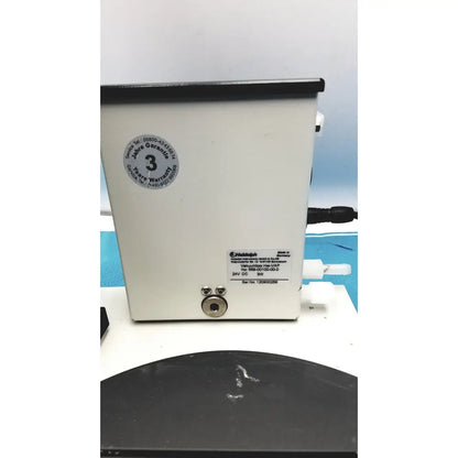 White rectangular volumetric pump with black top edge and 3 years warranty label on heidolph basis hei-vap rotary evaporator