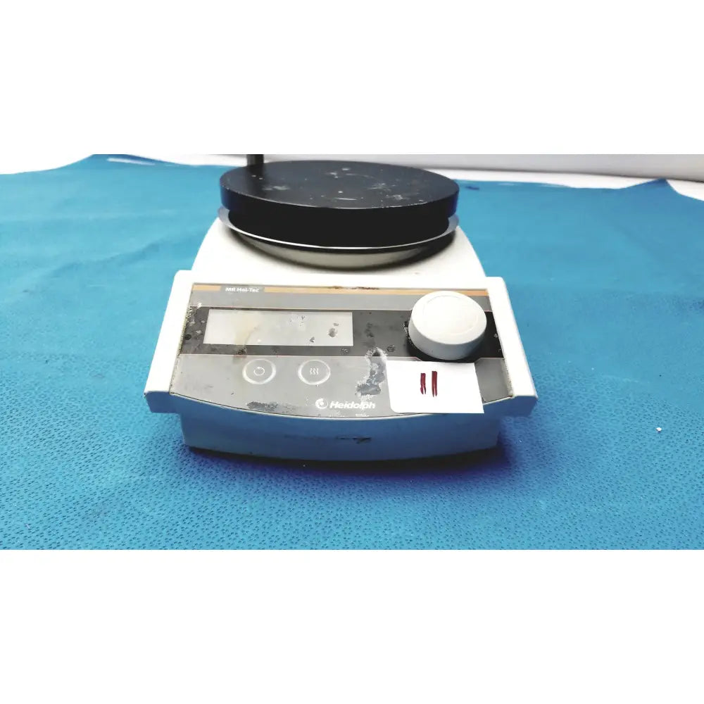 Used heidolph mr hei-tec magnetic stirrer hotplates with black stirring plate and white control panel showing wear