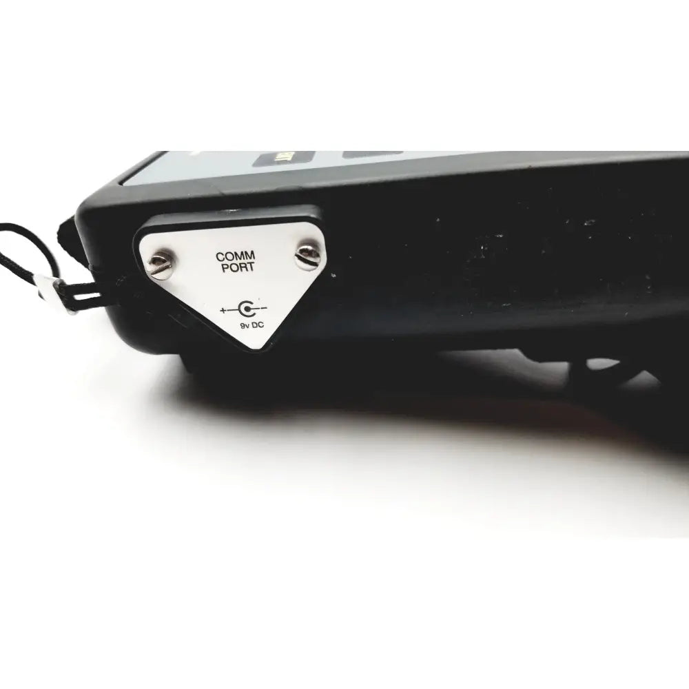 Black hand held calibrator with white comm port panel and 9v dc label heise calibrator 6d49 e171189 back side