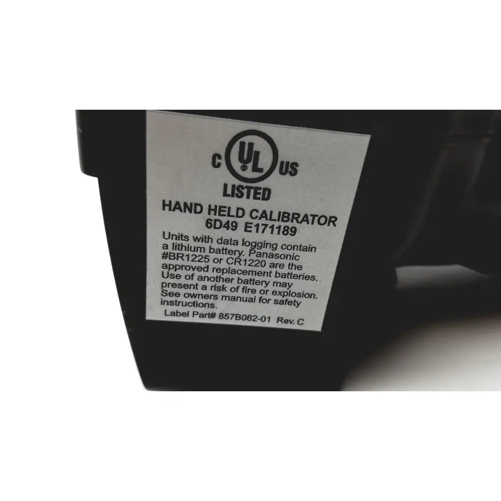 Black panasonic hand held calibrator 6d49 e171189 showing back with white label for safety and battery information