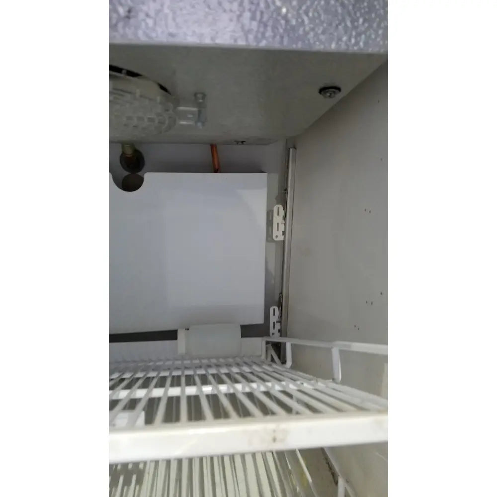 White wire shelf inside a helmer hlf105 horizon series laboratory freezer for organized sample storage