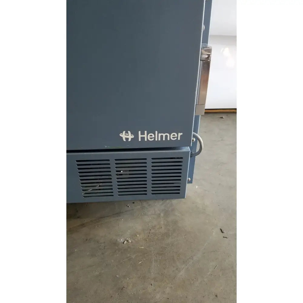 Helmer hlf105 horizon series laboratory freezer with gray helmer industrial oven, vented lower panel, and metallic handle