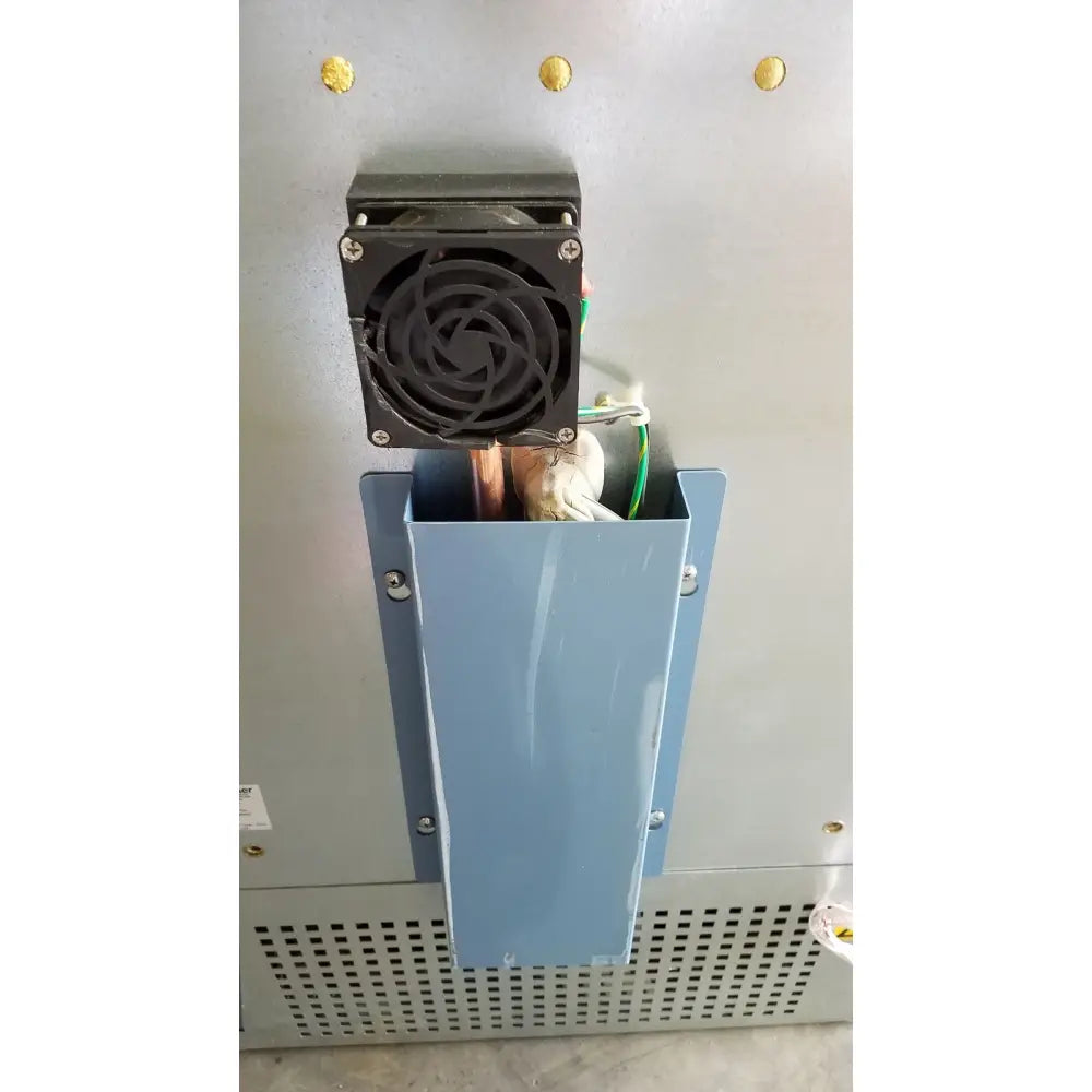 Black square cooling fan mounted on light blue metal housing of helmer hlf105 horizon series laboratory freezer back side