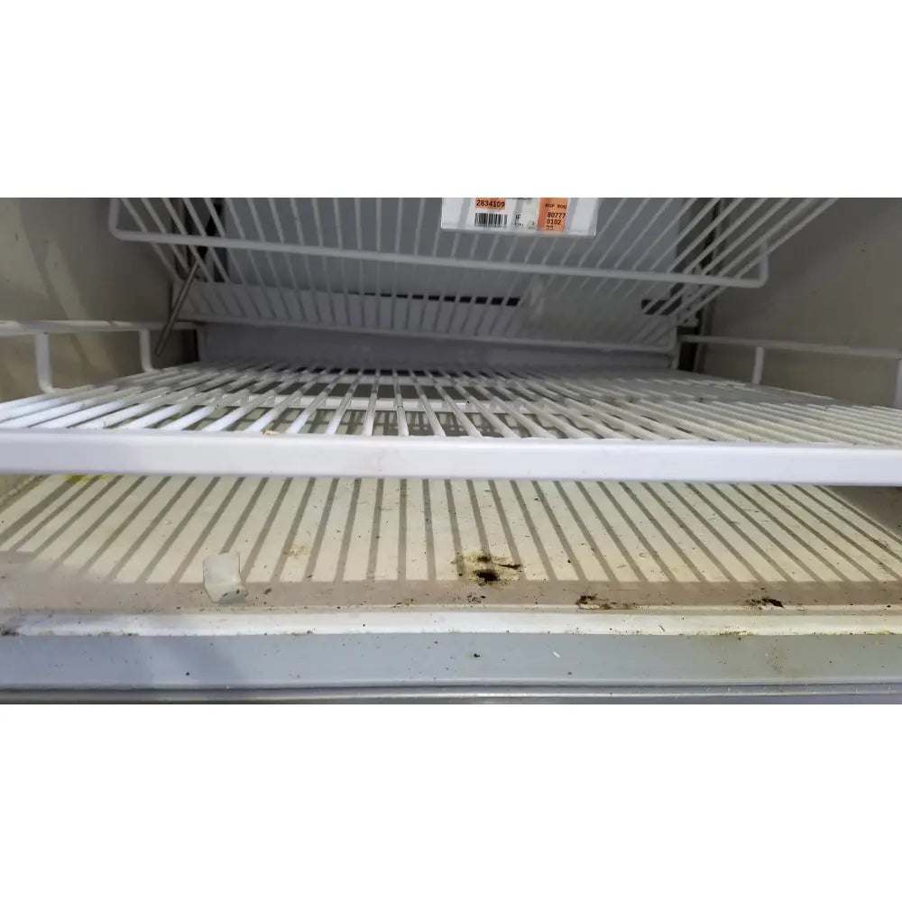 White plastic refrigerator shelf with vertical slats and dirt stains in helmer hlf105 horizon series laboratory freezer