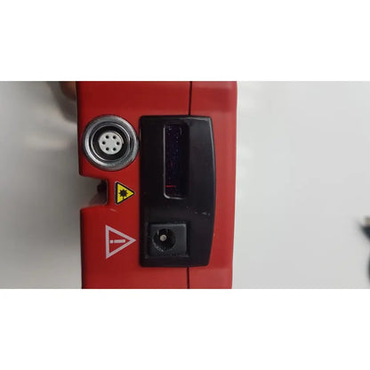 Red industrial laser scanner of hemoCue Hb 201 DM hemoglobin system analyzer with black display and circular port for reuse medical
