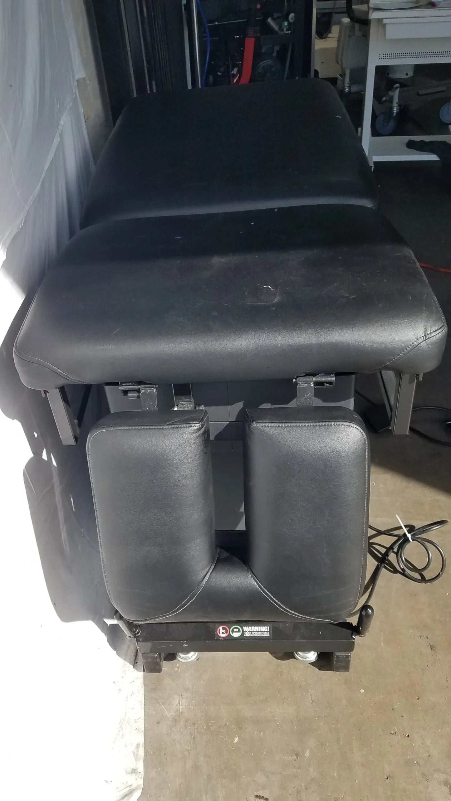 Black leather Hill HA90PT mobilization physical therapy treatment table with adjustable sections and padded headrests