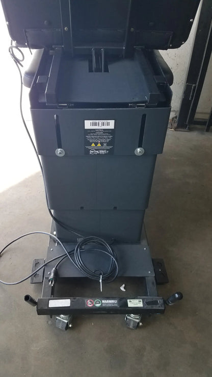 Black industrial-grade welding cart with casters and coiled power cord supporting hill ha90pt physical therapy treatment table