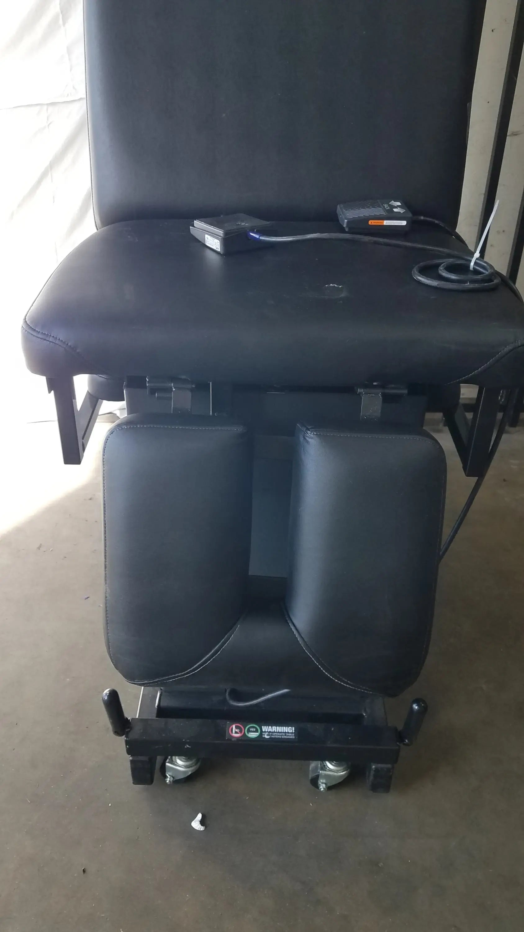 Black padded hill ha90pt mobilization physical therapy treatment table with adjustable footrests and caster wheels