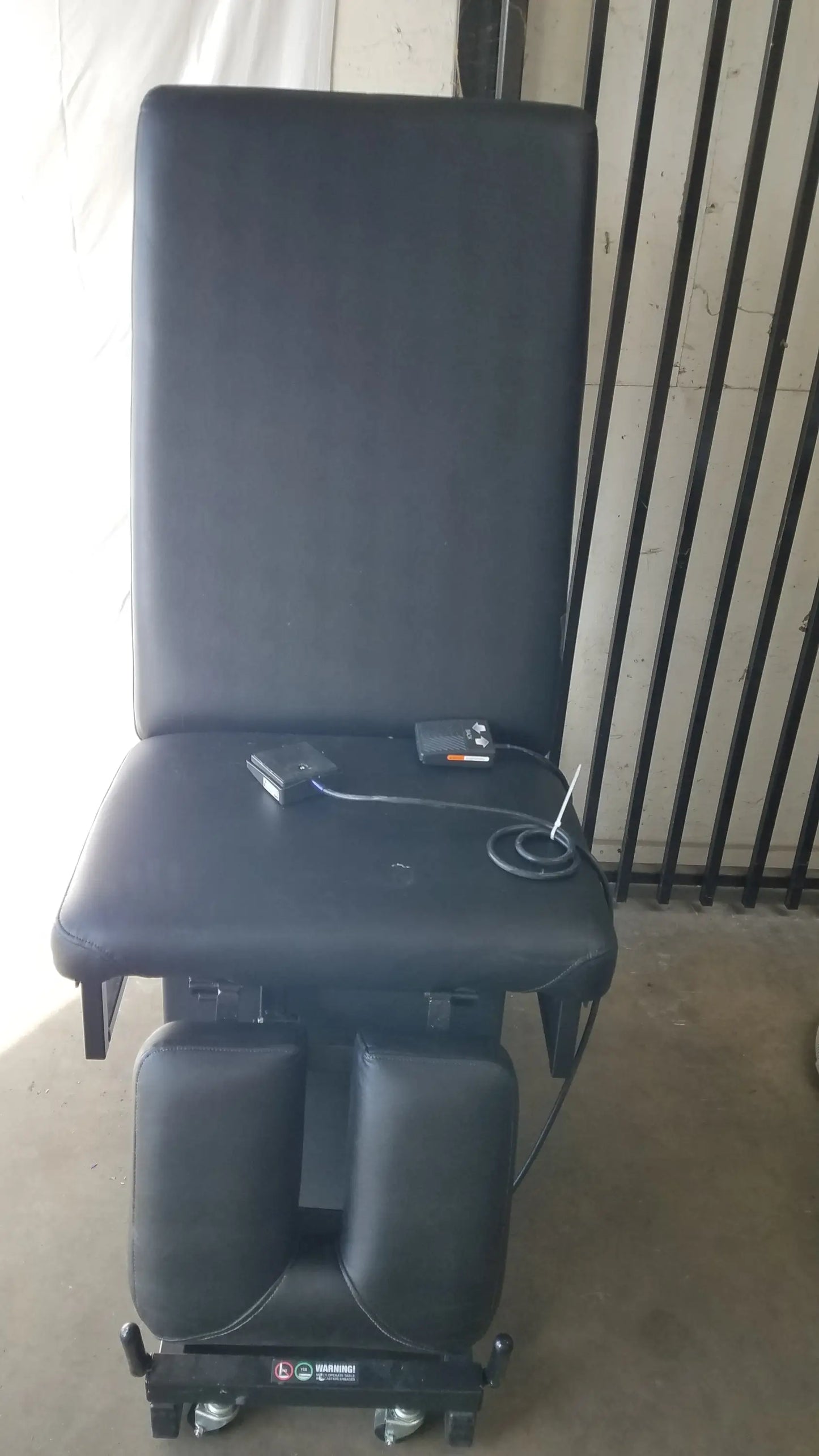 Black padded hill ha90pt mobilization physical therapy treatment table with adjustable footrest and control panel on seat