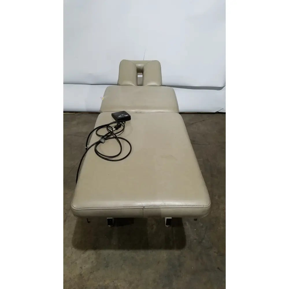Beige leather hill model ha90pt physical therapy treatment table with adjustable headrest and wheels for mobility