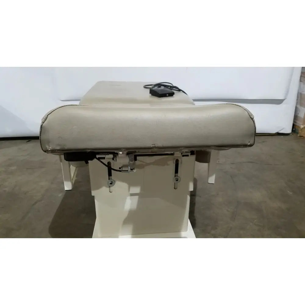 Beige upholstered hill model ha90pt physical therapy treatment table with padded headrest and metal frame
