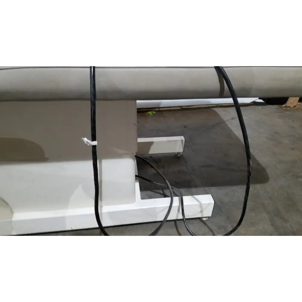 White industrial-grade roll-to-roll printing machine base with black cables on the side for hill model ha90pt physical therapy table