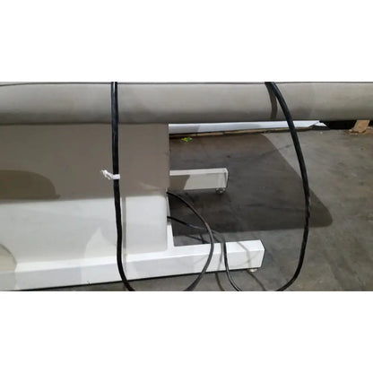 White industrial-grade roll-to-roll printing machine base with black cables on the side for hill model ha90pt physical therapy table