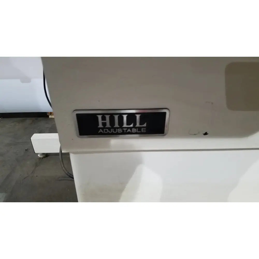 White hill model ha90pt physical therapy treatment table with black hill adjustable label plate on the back side