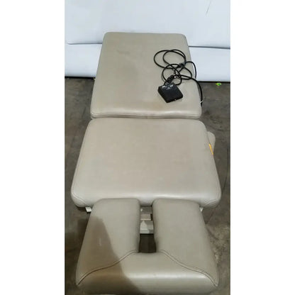 Beige leather hill model ha90pt physical therapy treatment table with segmented adjustable sections and black control unit