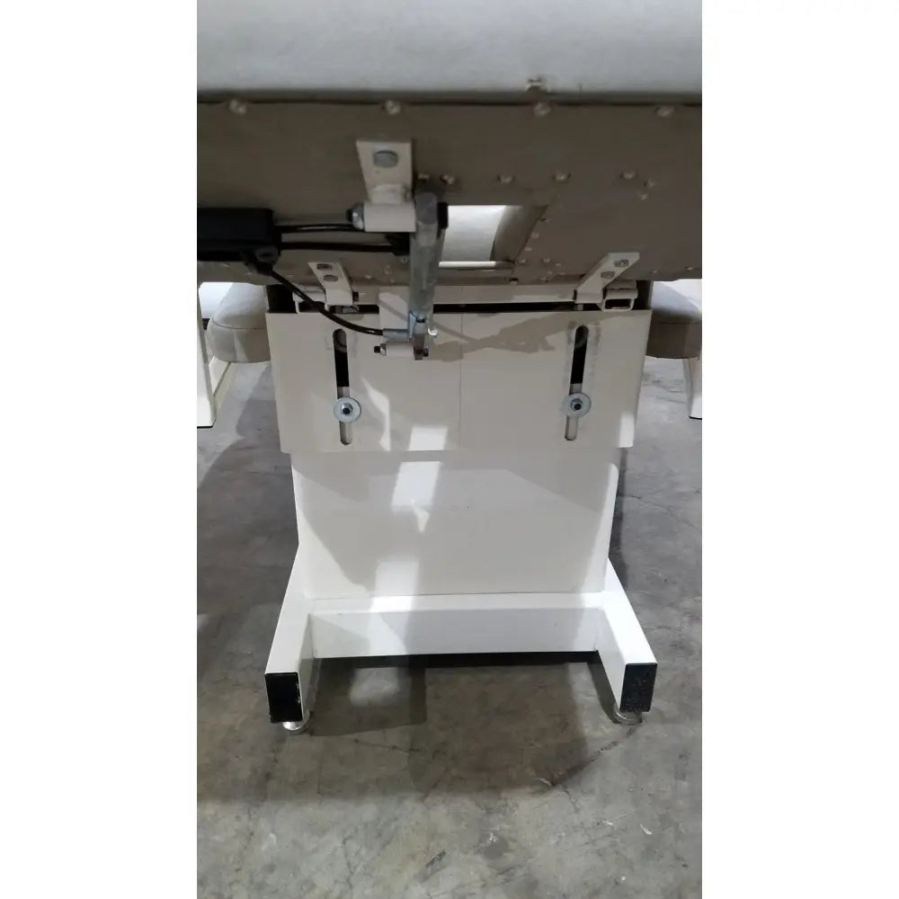 White adjustable massage table base with black caster wheels and metal brackets for hill model ha90pt physical use