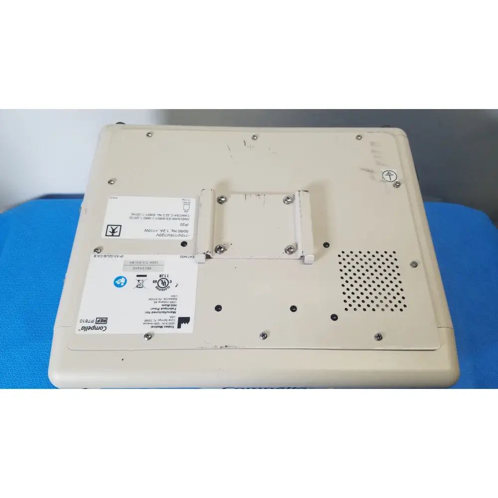 Beige plastic laptop base with screws ventilation holes and labels for p7810 compella bariatric therapy system back side