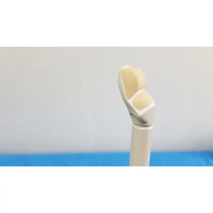 A beige and white smooth curved prosthetic finger alongside the hitachi cc41r ultrasound probe 8-4 mhz device