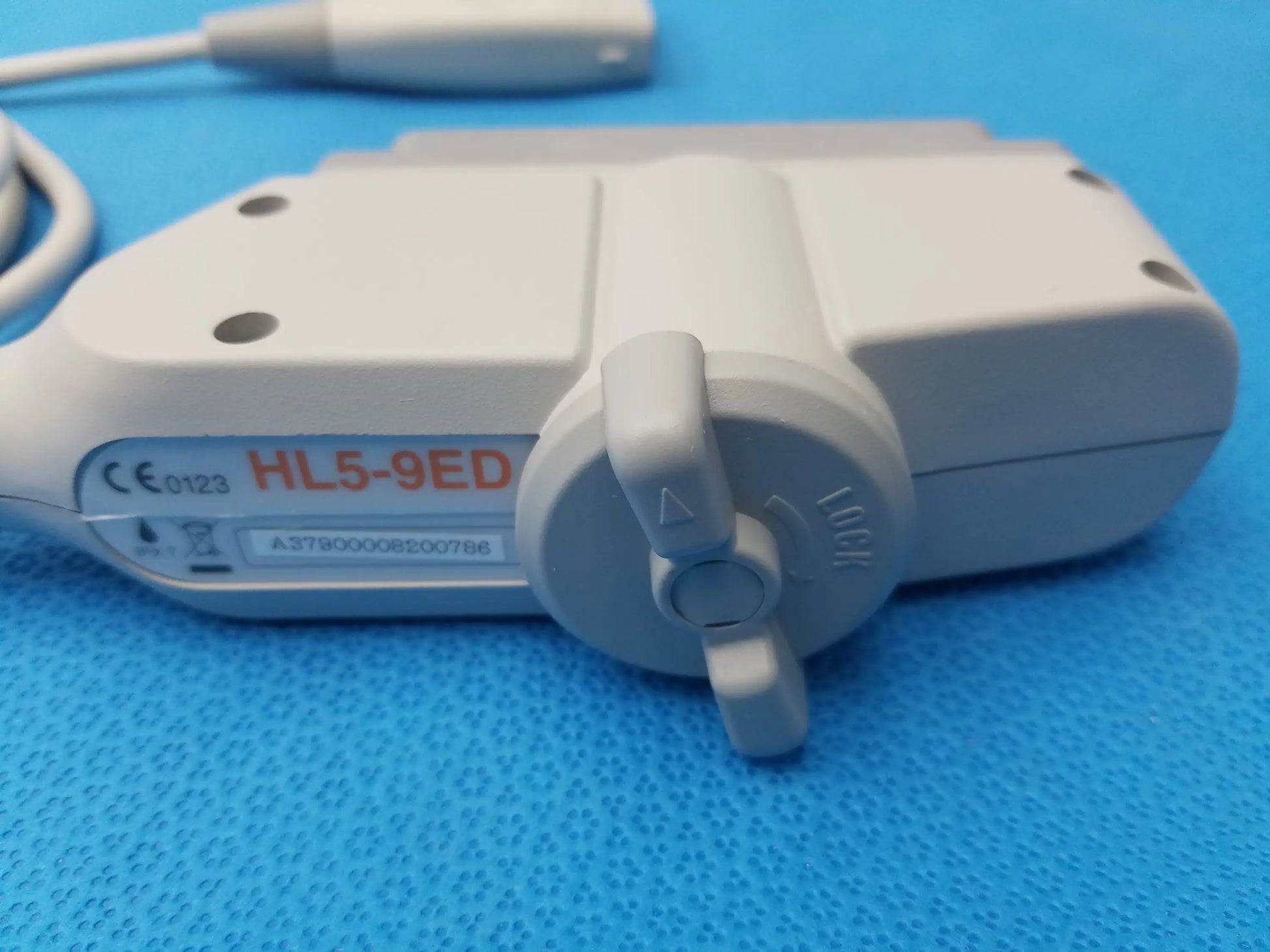 White plastic hl5-9ed linear ultrasound transducer probe with gray adjustment knob and attached cable for ultrasound imaging