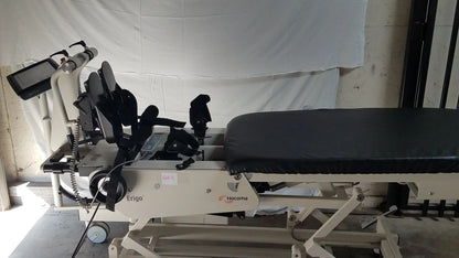 White and black hocoma erigo pro robotic tilt table with adjustable padded bed and control screen for verticalization therapy