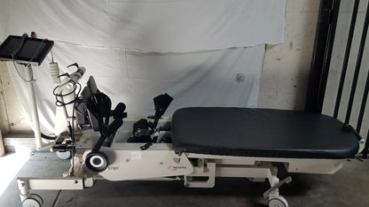 White medical rehabilitation robotic tilt table with black padded surface and adjustable armrests by hocoma ergo pro