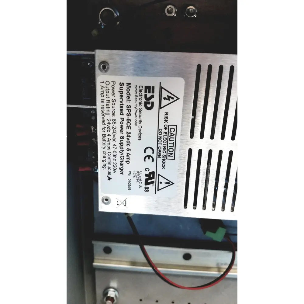 Silver metal power supply unit with black ventilation slits and white label on the back of hoffman steel type 1 cutout box