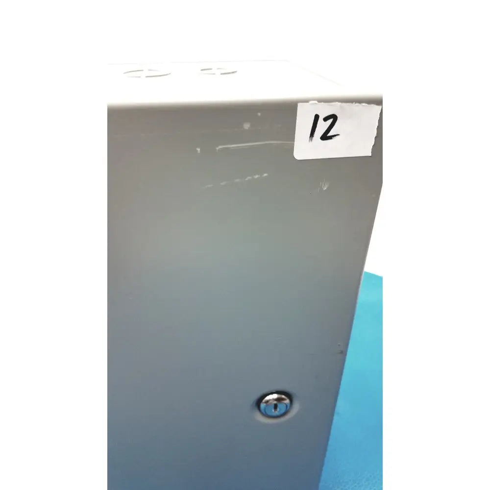 Gray metal hoffman steel type 1 cutout box with latch featuring a silver keyhole and white label marked 12 on top corner
