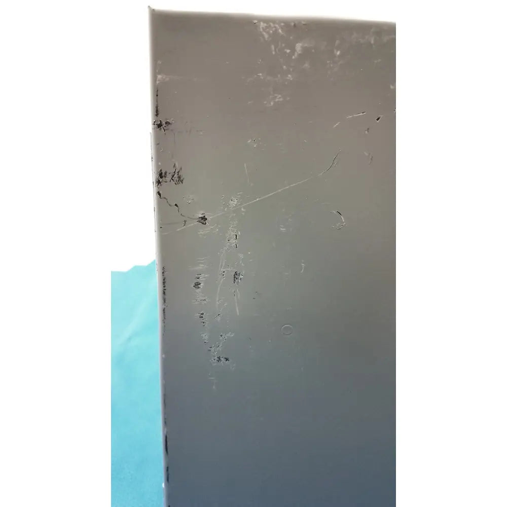 Matte gray scratched steel type rectangular panel with scuffs and minor cracks on hoffman steel type 1 cutout box