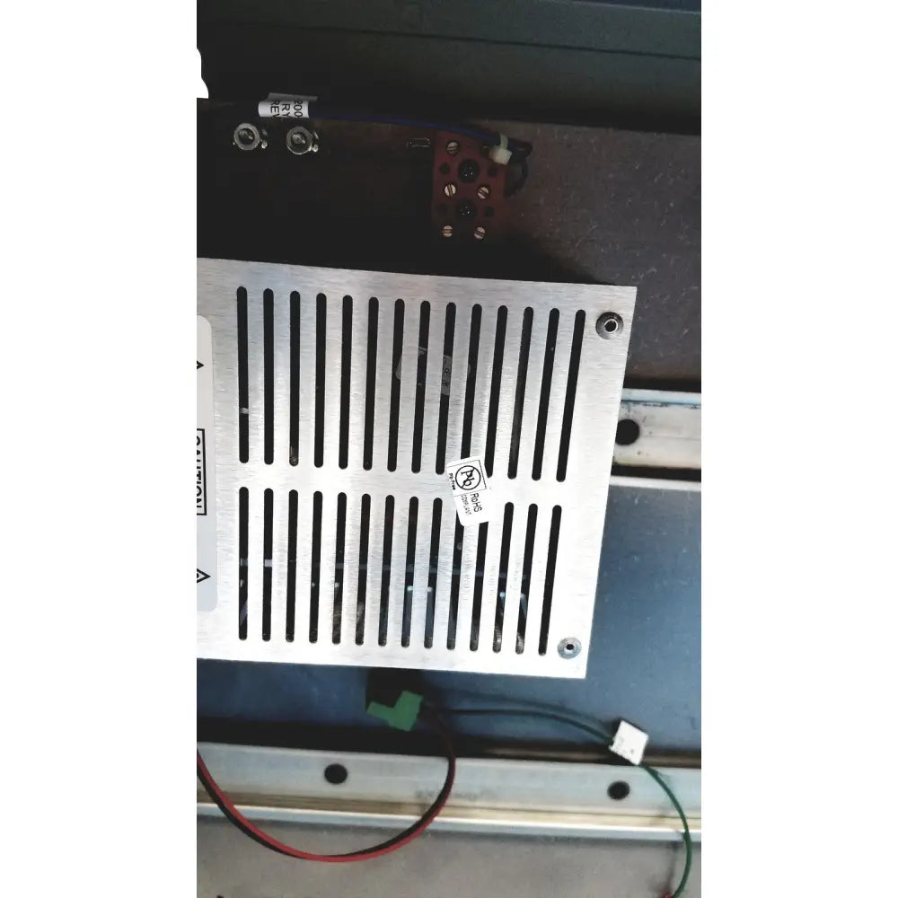 Silver metallic ventilation grille with vertical slats and four corner screws on hoffman steel type 1 cutout box