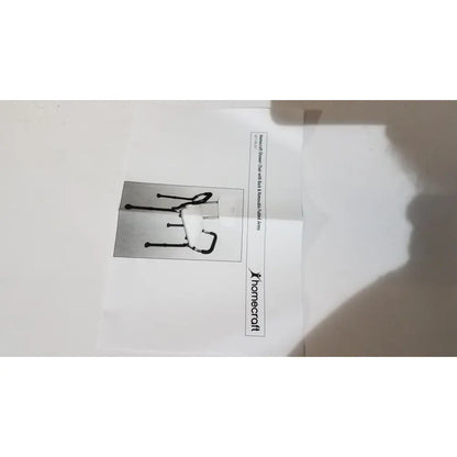 Black metal walker with curved handle and adjustable legs designed for use with homecraft shower chair padded removable arms