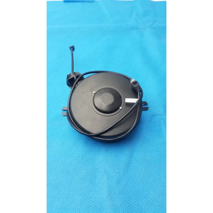 Black circular electric fan motor with coiled power cord and brackets for network grade retractable cable reel