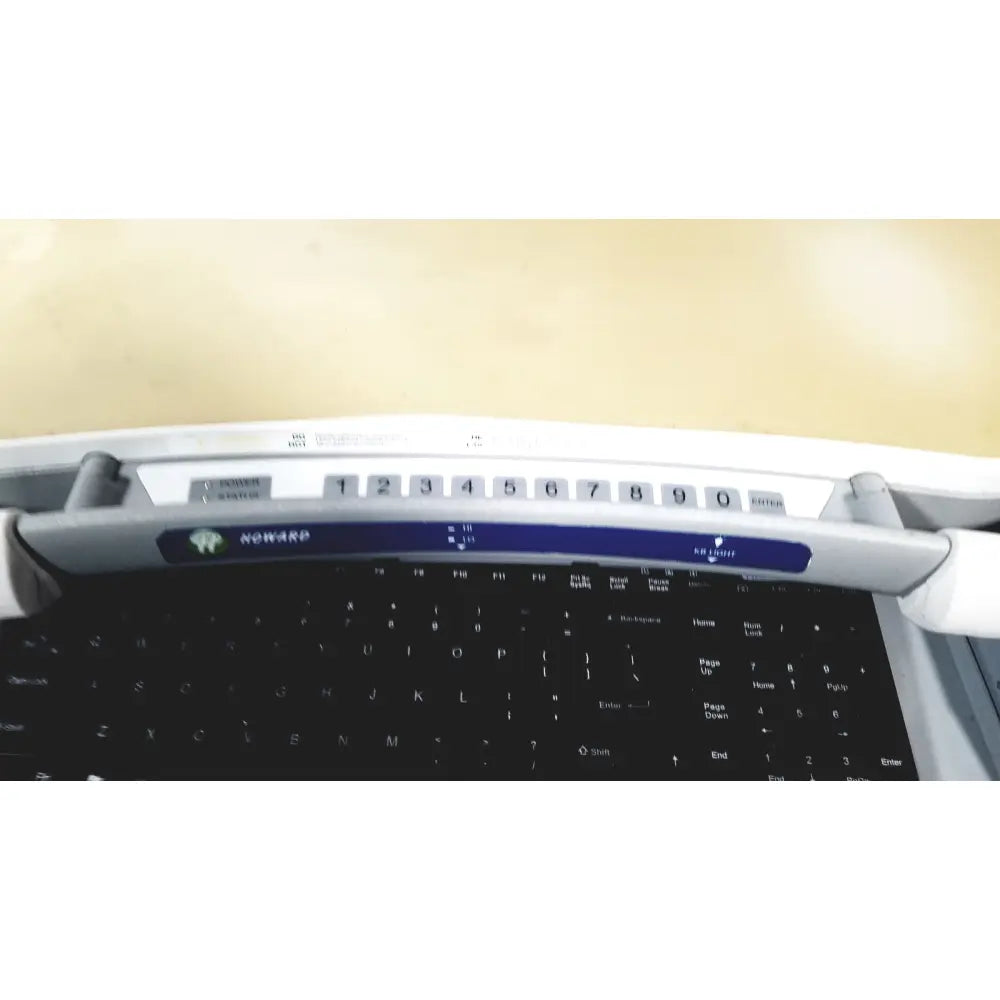 Howard Medical Hi-Care monitor and stand featuring a white and blue numeric keypad with black nowarp keys on laptop keyboard