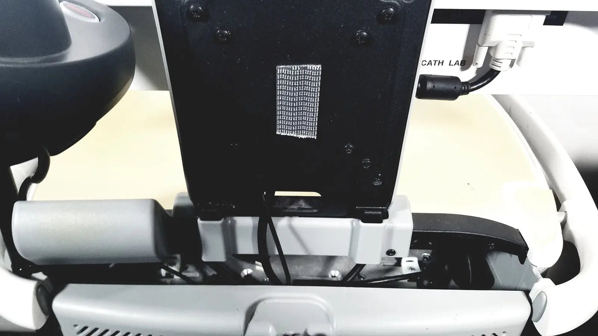 Black rectangular mesh vent panel with screws on the back of howard medical hi-care monitor and stand equipment