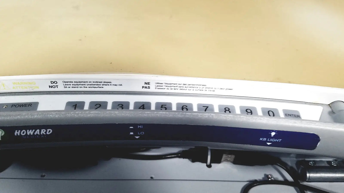Silver howard brand industrial control panel with numeric keypad and labeled buttons on howard medical hi-care monitor