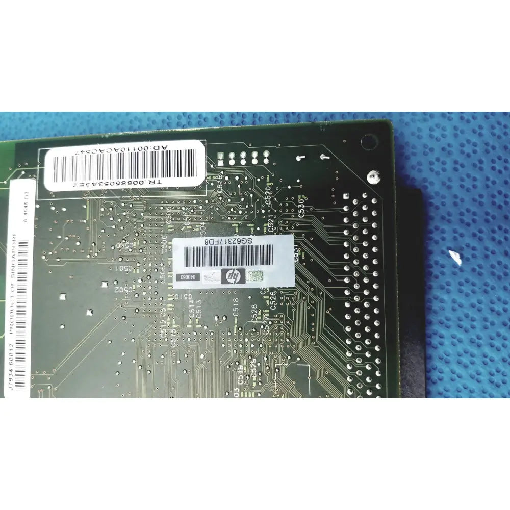 Green hp jetdirect 620n motherboard with silver circuitry and white barcode labels for fast ethernet print server use