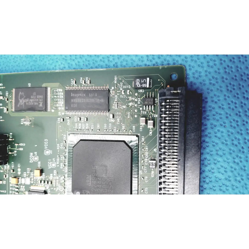 Green circuit board with black integrated circuits and large heat sink in hp jetdirect 620n fast ethernet print server