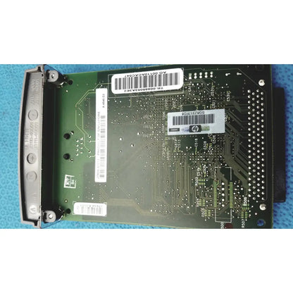 Green hp jetdirect 620n circuit board with silver solder points and white barcode labels for fast ethernet print server
