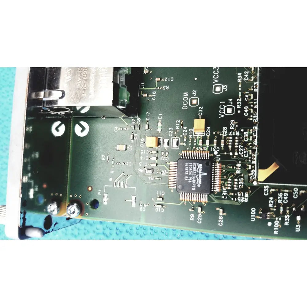 Green printed circuit board of hp jetdirect 620n fast ethernet print server with black ic chips and gold connectors