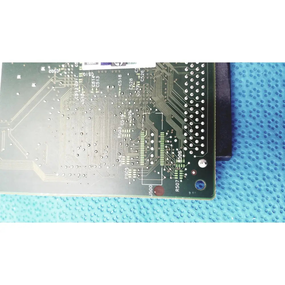 Green printed circuit board with silver traces and components of hp jetdirect 620n fast ethernet print server