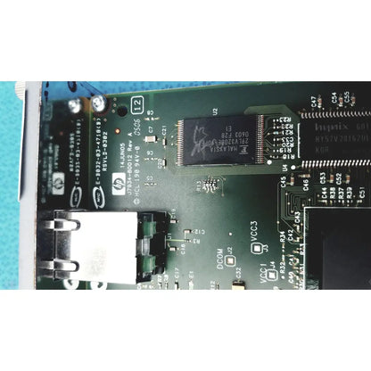 Green circuit board with black integrated circuits and silver connectors in hp jetdirect 620n fast ethernet print server
