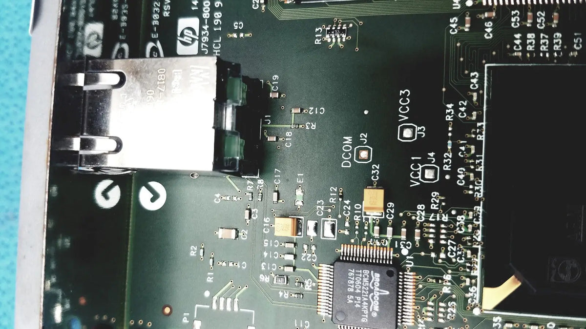 Black HP Jetdirect 620N motherboard with silver USB port and components for fast ethernet print server use